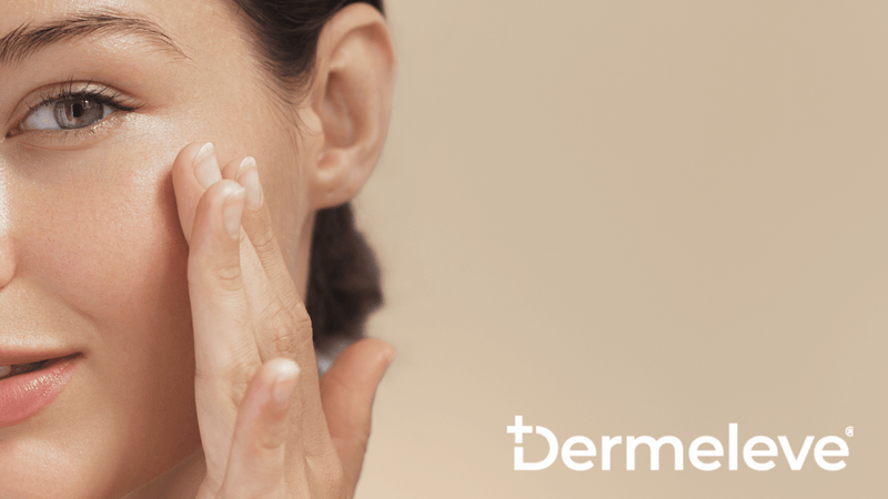 A woman touches her face with her hand